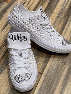 Embroidered Converse!Monochrome All WHITE Converse with pearls and rhinestones encrusted all over the shoe. !These shoes will sparkle and get noticed across the room! They are beautifully embroidered and hand done and each pair will be a bit different.This listing shows the Mrs (last name) and Wifey pattern but I can put your name or monogram on them. Your choice.  Message me your ideas!   Other options available in my shop!!Wear these at your reception so your feet don't hurt. You can do white Wedding White Embellished Sneakers, Low-top Wedding Shoes With Rhinestones For Bride, Bride's Low-top Wedding Shoes With Rhinestones, Low-top Bride Wedding Shoes With Rhinestones, Embellished Low-top Wedding Sneakers, White Embellished Low-top Wedding Shoes, Wedding Low-top Sneakers With Rhinestones, Converse With Pearls, Embroidered Wedding Shoes