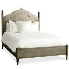 a bed with white linens and pillows on it's headboard, against a white background