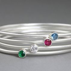 These sterling silver birthstone bangle bracelets make a perfect mother's day or grandmother gift. These modern, simple, stackable bracelets are made to order with the gemstone of your choice. These bracelets are made to order in about two days.Choose one bangle for each child.Bangles can be added to create a set--one bangle for each child.Stones are chosen according to child's birth month. This listing is for: One birthstone bangle in sterling silver with one tube set faceted, lab-created gemst Sterling Silver Stackable Bangle For Anniversary, Stackable Sterling Silver Bracelet For Anniversary, Sterling Silver Round Bracelet With Birthstone For Anniversary, Modern Sterling Silver Stackable Bracelet As Gift, Modern Stackable Sterling Silver Bracelet For Gift, Modern Stackable Sterling Silver Bracelet As Gift, Stackable Bangles, Grandmother Gifts, Stackable Bracelets