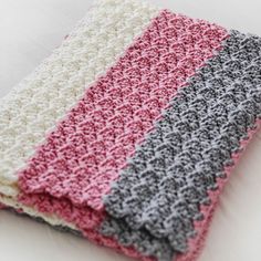 two crocheted dishcloths sitting next to each other