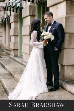 a bride and groom standing next to each other in front of a building with the caption's name on it