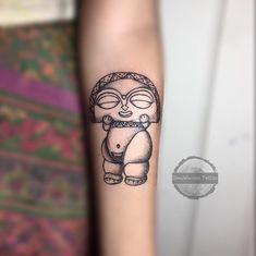 a small tattoo on the arm of a woman's left arm, with a cartoon character