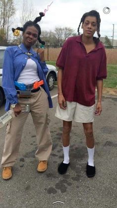 two people standing next to each other in a parking lot