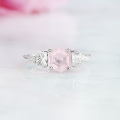 Gorgeous Hexagon Natural Rose Quartz Ring ►Made of solid sterling silver with rhodium finish (925) ►Accented with simulated diamonds (CZ) ►Average band width: 1.7 mm. Center Stone: Rose Quartz Color: Pink Gemstone creation: Natural Shape: Hexagon Measurements: 7.0 mm Carat Weight: 1.2 ct. (approx.) Hardness (Mohs hardness scale): 7 Luster: Vitreous Healing properties: Lowering stress and tension in the heart, Rose Quartz clears out anger, jealousy, and resentment of others, and allows healing of Rose Quartz Color, Gemstone Engagement Ring, Quartz Engagement Ring, Popular Engagement Rings, Green Amethyst Ring, Rose Quartz Ring, Gemstone Engagement, Wedding Ring Designs, Pink Gemstones