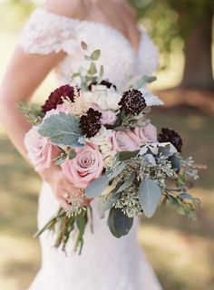 a bride holding a bouquet of flowers in her hands