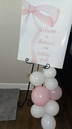 a welcome sign with balloons in front of it and a welcome sign on the back