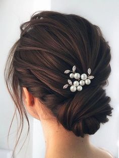 a woman wearing a hair comb with pearls on it