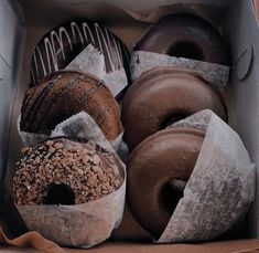 an open box filled with assorted donuts