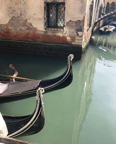 two gondolas tied to the side of a building