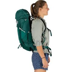 a woman with a green backpack on her back