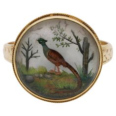 Past Sights Beautiful example of Victorian period Essex Crystal reverse intaglio ring depicting birds into natural scene like a window on Eden garden, beautiful carving highly detailed and painted, artistic past technique giving the subject trompe l’oeil effect Mounting hand made of solid 18 KT gold, close back with chased foliage to the band Fine wearable condition Technique: Rock crystal from Madagascar or Brazil hand polished by hand, with a progressively fine polishing tool to create a domed Reverse Intaglio, Intaglio Ring, Eden Garden, Garden Beautiful, Victorian Period, Victorian Women, Rock Crystal, Signet Ring, Madagascar