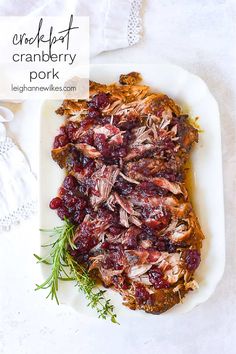 cranberry pork roast on a white platter