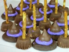 there are many chocolate candies with candles on the top one is purple and gold