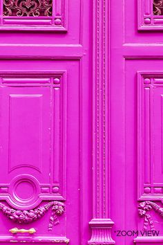 a pink door with ornate carvings on it