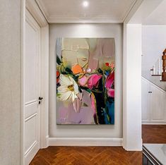 an abstract painting hangs on the wall in a hallway