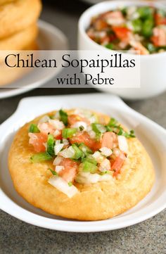 some food is sitting on a plate with the words chilean sopapillas with pebe