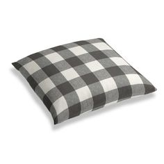 a black and white checkered pillow on a white background