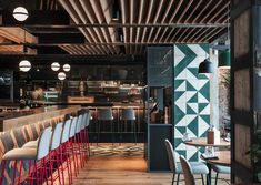 a bar with chairs and tables in front of it