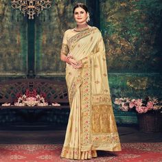 Beige colored festive wear saree. This saree is made from banarasi silk fabric which is highlighted with beautiful woven work as shown. Comes along unstitched banarasi silk blouse piece which you can customise as per your design/style. Occasion - You can wear this saree for festive, special occasions, ideal for any fashionista. Style it up - Look glamorous in this traditional saree by (SANGAM PRINTS) Pair this saree with beautiful clutch to complete the look!!Note:- The actual product may differ Saree Banarasi, Traditional Saree, Banarasi Silk Saree, Festive Wear, Wear Saree, Designer Saree, Traditional Sarees, Yellow Fabric, Blouse Piece