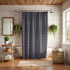 a bath room with a shower curtain and a rug