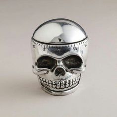 a silver skull with a measuring tape on it's head is shown in front of a white background