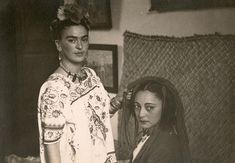 two women standing next to each other in a room