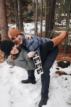 two people standing in the snow posing for a photo