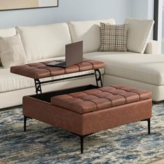 a living room with a couch, ottoman and coffee table