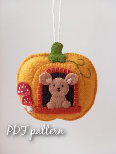 a pumpkin shaped ornament with a mouse on it