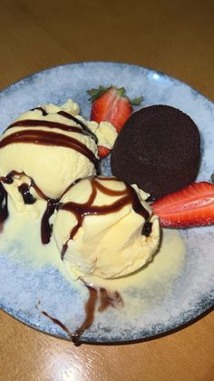 three ice cream sundaes on a blue plate