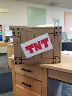 a cardboard box with the word tnt on it sitting on top of a desk