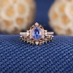 a tan and blue ring sitting on top of a blue cloth