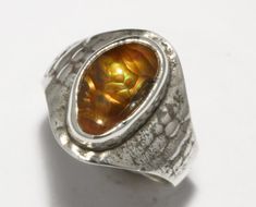 Elevate your style with this exquisite handcrafted fire agate silver ring. This one-of-a-kind piece showcases the beauty of fire agate  with its captivating play of colors that dance like flames. Set in a high-quality sterling silver band  this unique ring is a wearable work of art.  Add a touch of artistry to your jewelry collection today!  I can resize this upon request at no extra cost. Size: 10.5 Weight: 8.9gm. Form: 15x10mm freeshape Fire Agate Ring, Fire Agate, Agate Ring, Unique Ring, Size 10 Rings, Sterling Silver Bands, Silver Band, Rings Statement, Unique Rings