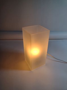 a light that is on top of a white surface with a cord in front of it