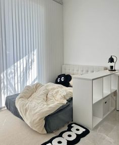 a bedroom with a bed and desk in it