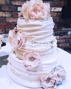 there is a wedding cake with flowers on it