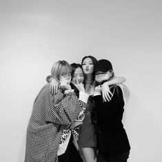 black and white photograph of four women hugging each other