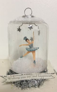 a snow globe with a ballerina in it