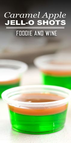 two plastic cups filled with jello shots sitting on top of a white countertop