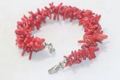 Vintage costume bracelet that features coral stones throughout. This bracelet is meant to fit a 7.5 inch wrist and been checked by a professional for authenticity. Coral Bangle Bracelet As Gift, Handmade Elegant Red Coral Bracelets, Elegant Handmade Red Coral Bracelets, Elegant Handmade Coral Bracelet, Adjustable Red Coral Bracelets, Elegant Adjustable Red Coral Bracelet, Elegant Red Coral Adjustable Bracelet, Wedding Bracelets, Coral Bracelet