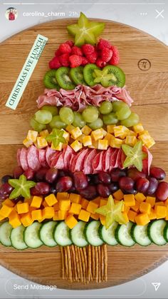 a christmas tree made out of fruits and veggies on a wooden platter