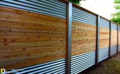 a wooden fence with metal slats on it