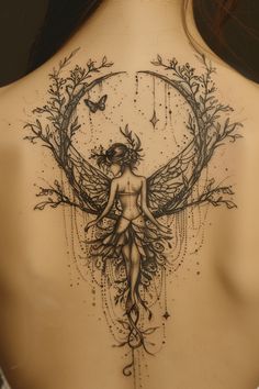 a woman's back with a tattoo design on it