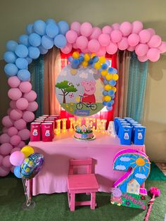 a table set up with balloons and decorations for a peppa pig birthday party at home