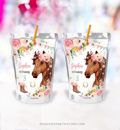 two cups with horses and flowers on them are shown in front of a blurry background