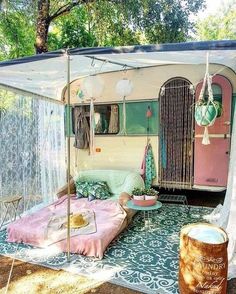 an old camper trailer is converted into a bed and tent for the kids to sleep in