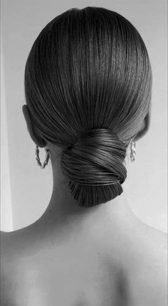 black and white photograph of a woman's back with her hair in a low bun