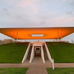 an orange structure with stairs leading up to it