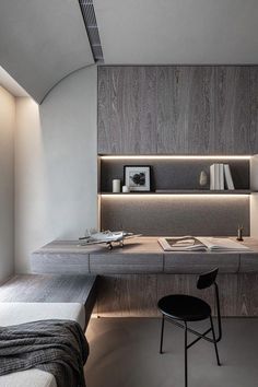 a bedroom with a desk and chair in the corner next to a wall mounted bookshelf