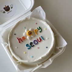 a birthday cake with the words happy seou written on it sitting in a box